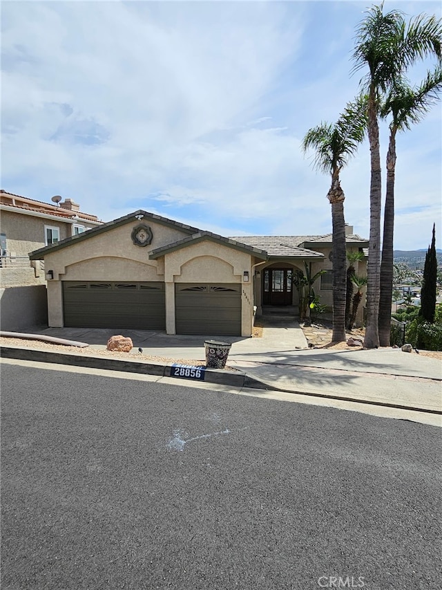 28856 Yosemite Pl, Canyon Lake, CA 92587 - view of front of property featuring a garage, stucco siding, and concrete driveway