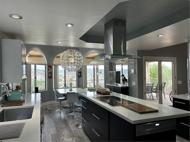 28856 Yosemite Pl, Canyon Lake, CA 92587 - kitchen with black electric stovetop, island range hood, dark cabinets, wood finished floors, and light countertops