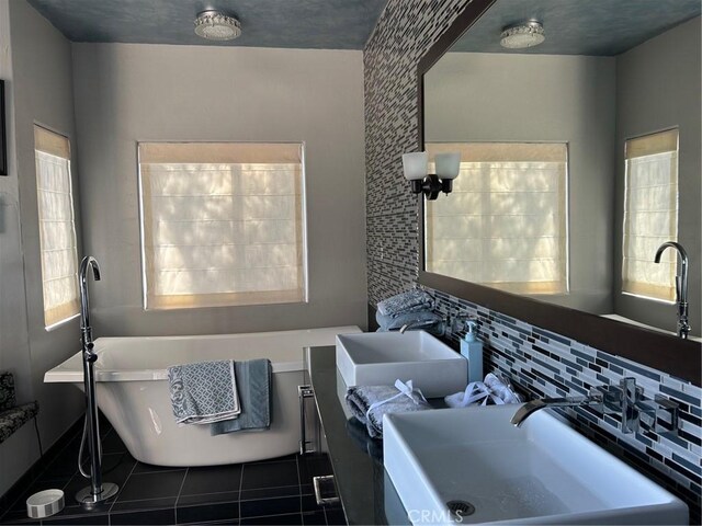28856 Yosemite Pl, Canyon Lake, CA 92587 - full bathroom with tile patterned flooring, a freestanding tub, tasteful backsplash, vanity, and baseboards