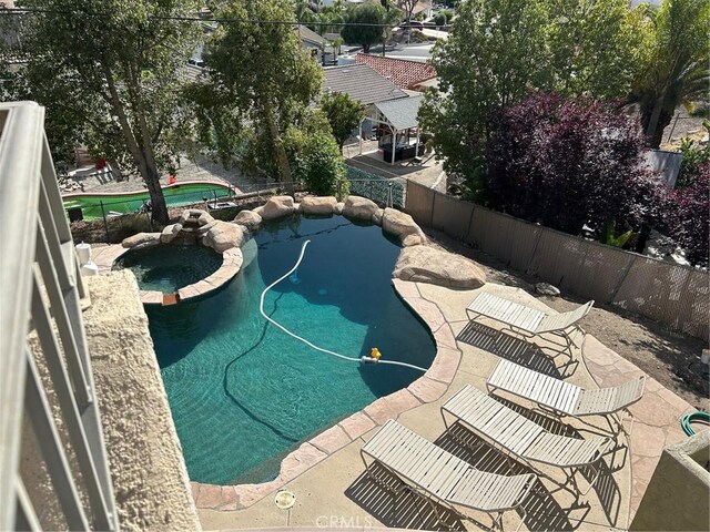 28856 Yosemite Pl, Canyon Lake, CA 92587 - view of swimming pool with a pool with connected hot tub, a fenced backyard, and a patio area