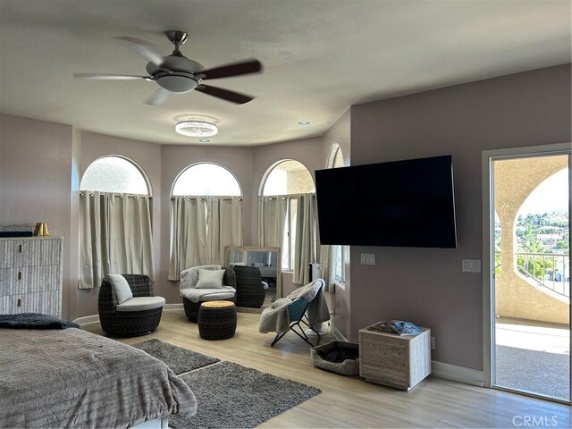 28856 Yosemite Pl, Canyon Lake, CA 92587 - bedroom featuring access to outside, wood finished floors, multiple windows, and baseboards