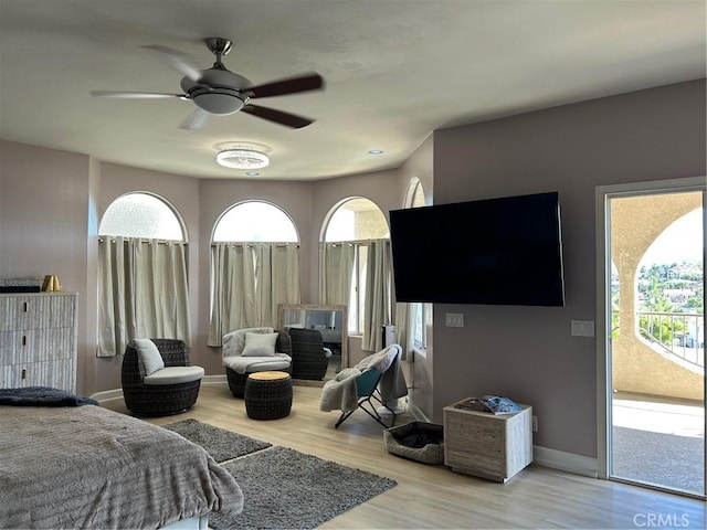 28856 Yosemite Pl, Canyon Lake, CA 92587 - bedroom with access to exterior, wood finished floors, multiple windows, and ceiling fan