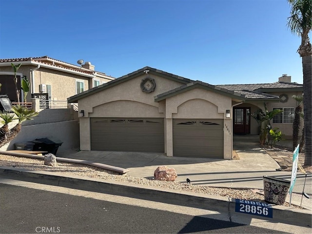 28856 Yosemite Pl, Canyon Lake, CA 92587 - view of front of house with stucco siding, a garage, concrete driveway, a chimney, and a tiled roof