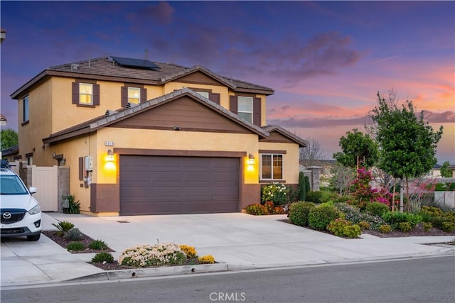 view of front of home with solar panels, stucco siding, and a tiled roof