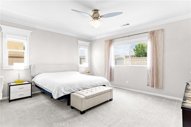 bedroom with crown molding, carpet floors, baseboards, and a ceiling fan
