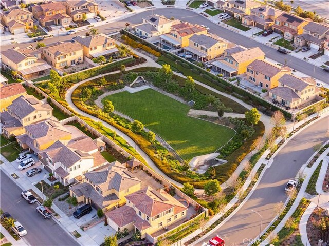 aerial view of property and surrounding area featuring nearby suburban area
