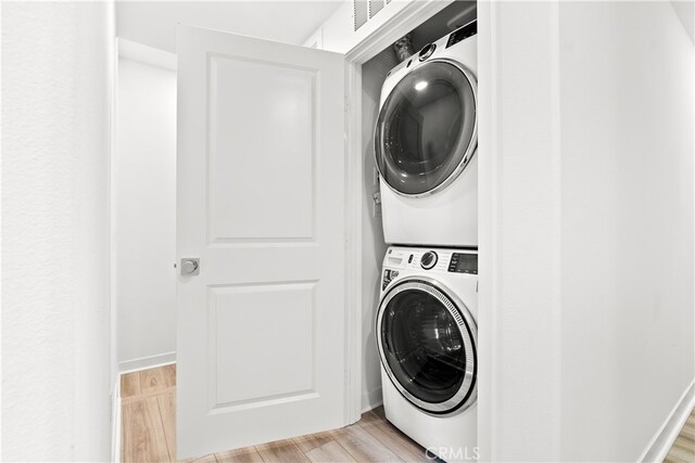 1201 Lasso Way Unit 202, Rancho Mission Viejo, CA 92694 - clothes washing area featuring stacked washer / dryer and light wood-style flooring