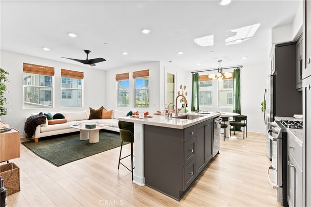 1201 Lasso Way Unit 202, Rancho Mission Viejo, CA 92694 - kitchen with stainless steel appliances, open floor plan, a sink, light wood-type flooring, and recessed lighting