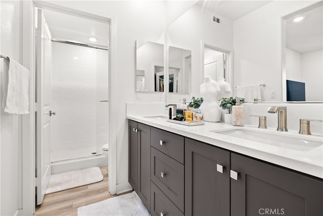 1201 Lasso Way Unit 202, Rancho Mission Viejo, CA 92694 - bathroom with wood finished floors, a shower stall, double vanity, toilet, and recessed lighting