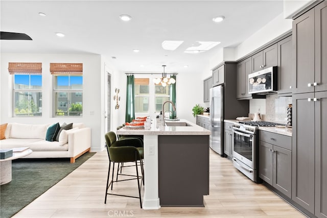1201 Lasso Way Unit 202, Rancho Mission Viejo, CA 92694 - kitchen featuring stainless steel appliances, a sink, gray cabinetry, a chandelier, and recessed lighting