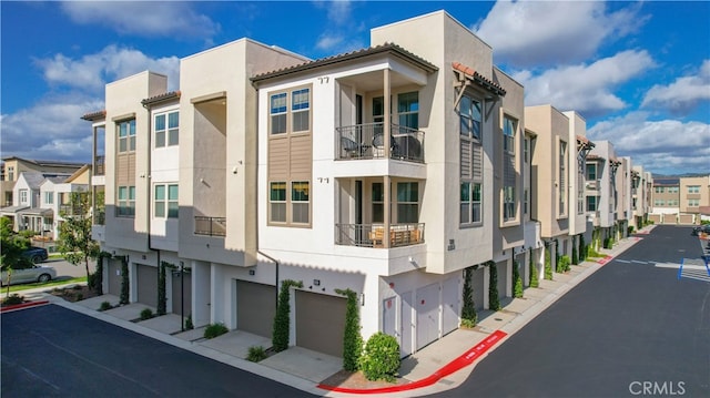 1201 Lasso Way Unit 202, Rancho Mission Viejo, CA 92694 - view of building exterior with a residential view and a garage