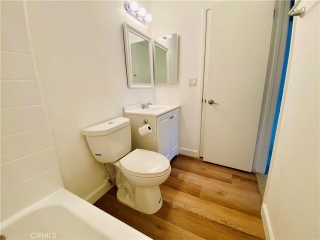 1061 Dawson Ave, Long Beach, CA 90804 - full bathroom featuring wood finished floors, toilet, vanity, and baseboards