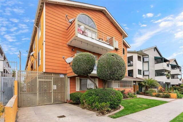 1061 Dawson Ave, Long Beach, CA 90804 - view of front of house with a balcony and fence