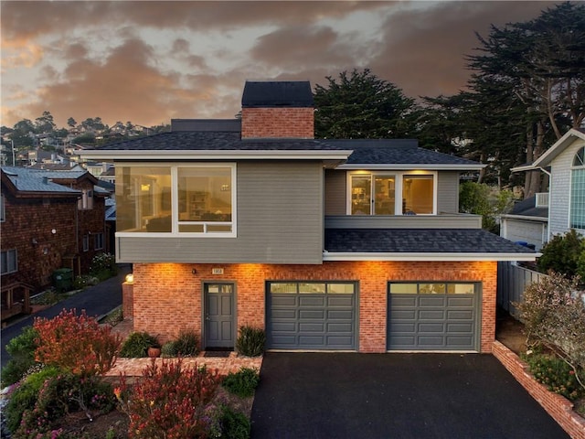 1850 Laurel Pl, Cambria, CA 93428 - view of front facade featuring driveway, brick siding, a garage, a chimney, and a shingled roof