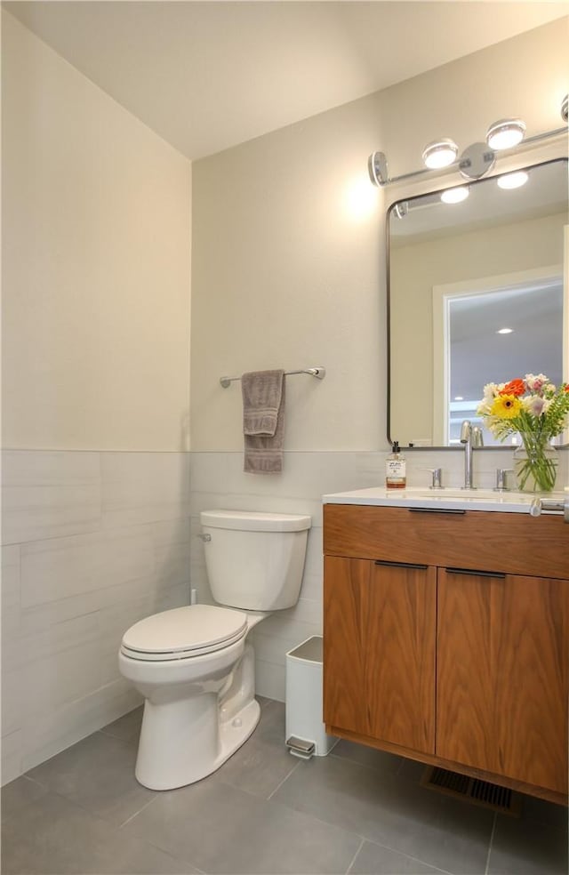 1850 Laurel Pl, Cambria, CA 93428 - bathroom with tile patterned flooring, toilet, tile walls, vanity, and wainscoting