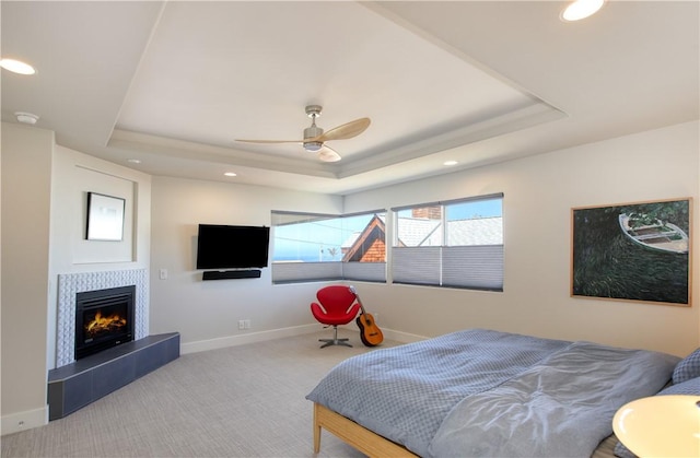 1850 Laurel Pl, Cambria, CA 93428 - carpeted bedroom featuring a tray ceiling, baseboards, recessed lighting, a tile fireplace, and ceiling fan