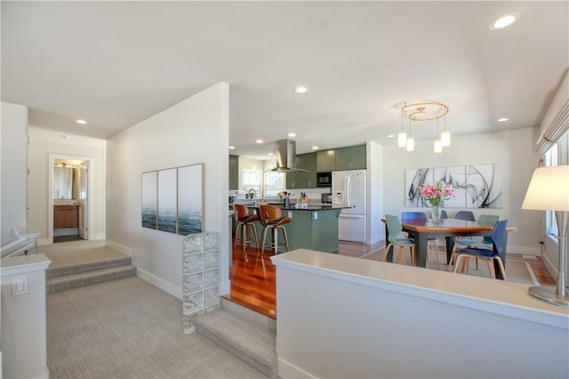 1850 Laurel Pl, Cambria, CA 93428 - kitchen featuring white refrigerator with ice dispenser, island range hood, black microwave, recessed lighting, and dark countertops