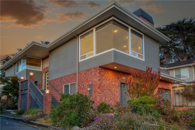 1850 Laurel Pl, Cambria, CA 93428 - view of side of home with brick siding, stairs, and a chimney