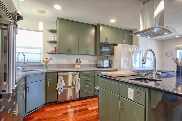 1850 Laurel Pl, Cambria, CA 93428 - kitchen with green cabinets, stainless steel dishwasher, island exhaust hood, black microwave, and wood finished floors