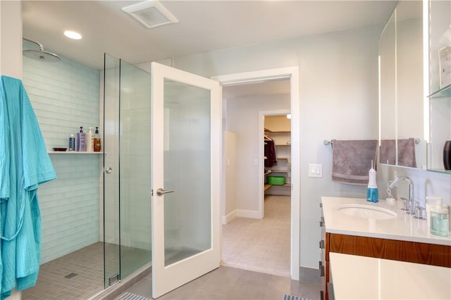 1850 Laurel Pl, Cambria, CA 93428 - full bathroom featuring vanity, a shower stall, a walk in closet, tile patterned flooring, and recessed lighting