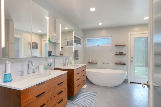1850 Laurel Pl, Cambria, CA 93428 - bathroom featuring a freestanding tub, two vanities, tile patterned floors, and recessed lighting