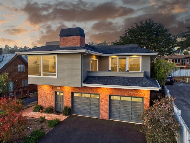 1850 Laurel Pl, Cambria, CA 93428 - view of front of home with a garage, a chimney, asphalt driveway, and brick siding