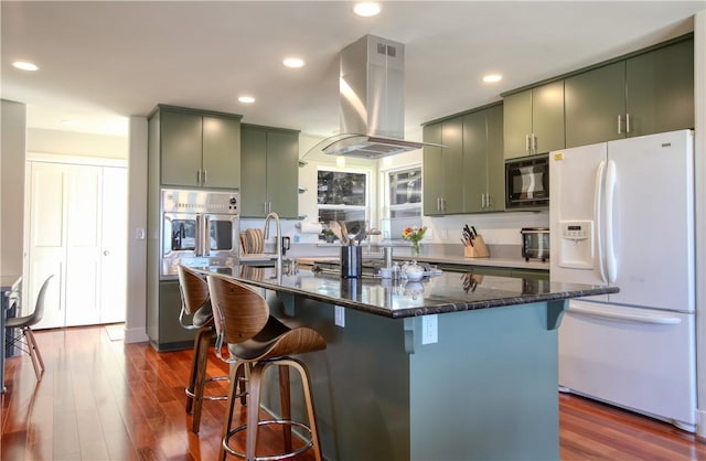 1850 Laurel Pl, Cambria, CA 93428 - kitchen featuring white refrigerator with ice dispenser, green cabinets, black microwave, oven, and recessed lighting