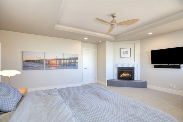 1850 Laurel Pl, Cambria, CA 93428 - bedroom featuring a tray ceiling, recessed lighting, a tiled fireplace, baseboards, and ceiling fan