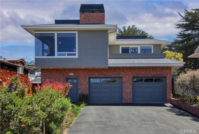1850 Laurel Pl, Cambria, CA 93428 - view of front of property with a chimney, asphalt driveway, an attached garage, and brick siding