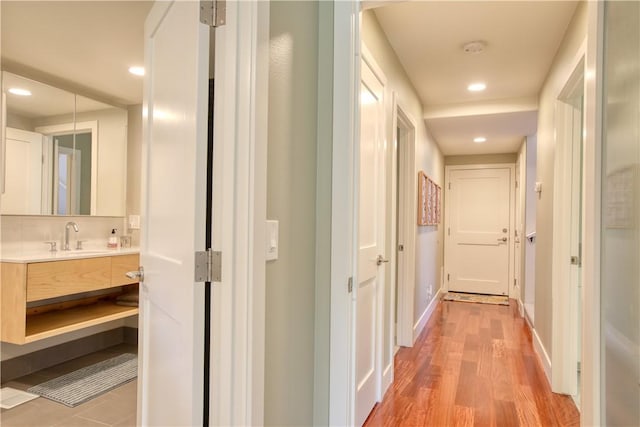 1850 Laurel Pl, Cambria, CA 93428 - hallway with a sink, light wood-style floors, recessed lighting, and baseboards