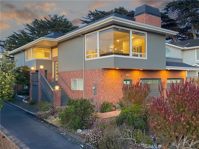 1850 Laurel Pl, Cambria, CA 93428 - property exterior at dusk featuring brick siding and a chimney