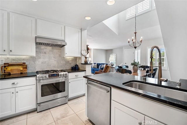 69 Cloudcrest, Aliso Viejo, CA 92656 - kitchen featuring appliances with stainless steel finishes, ventilation hood, a sink, dark countertops, and a chandelier