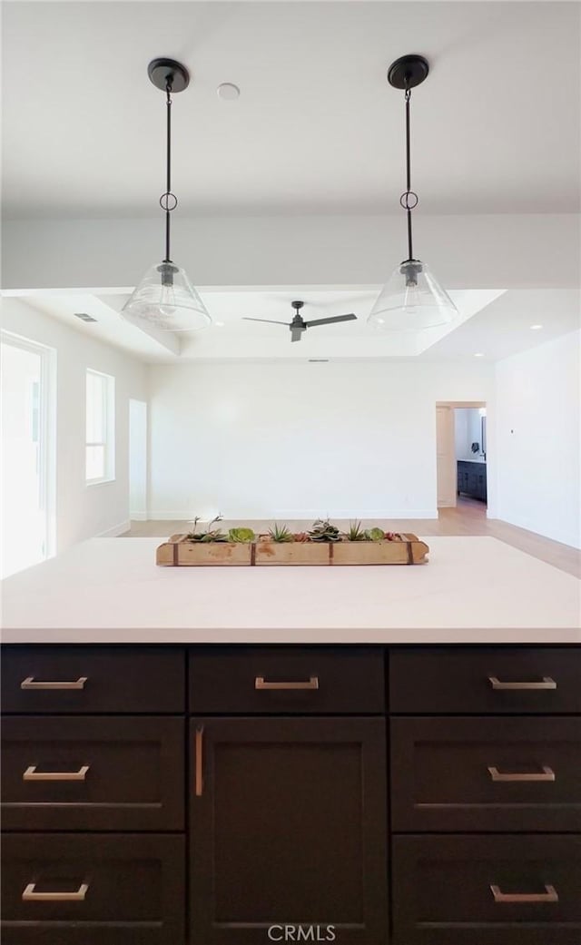2822 Mariposa Ave, Chico, CA 95973 - kitchen featuring light countertops, dark brown cabinetry, and decorative light fixtures