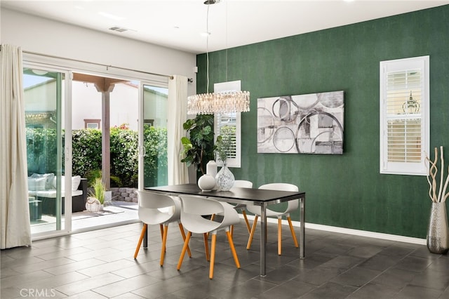 4699 S Moneta Privado, Ontario, CA 91761 - dining area with wallpapered walls, baseboards, a chandelier, and an accent wall