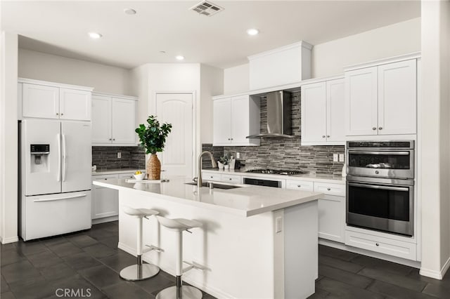 4699 S Moneta Privado, Ontario, CA 91761 - kitchen with stainless steel appliances, wall chimney range hood, a sink, tasteful backsplash, and a center island with sink