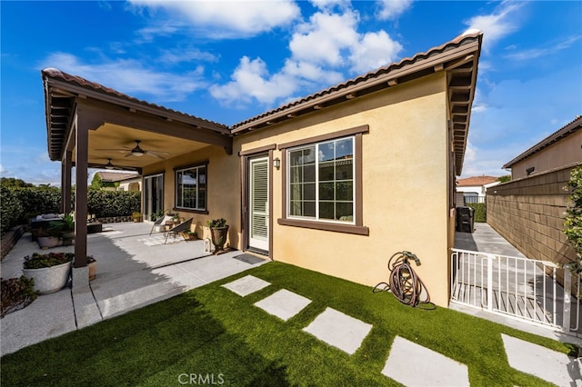 4699 S Moneta Privado, Ontario, CA 91761 - back of property with ceiling fan, stucco siding, and a patio