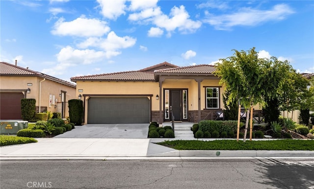 4699 S Moneta Privado, Ontario, CA 91761 - mediterranean / spanish home with an attached garage, a tiled roof, stucco siding, and concrete driveway