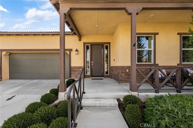 4699 S Moneta Privado, Ontario, CA 91761 - property entrance with stucco siding, an attached garage, and concrete driveway