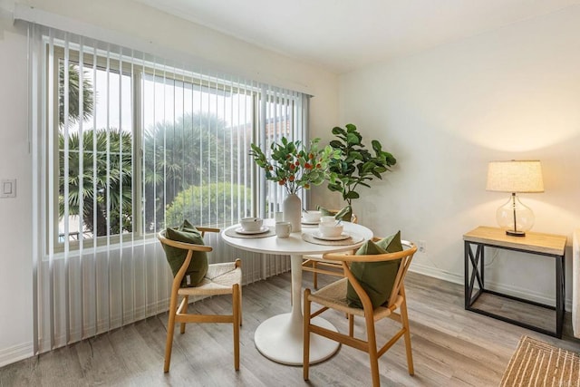 2929 Fire Mountain Dr Unit 9, Oceanside, CA 92054 - dining area with wood finished floors, plenty of natural light, and baseboards