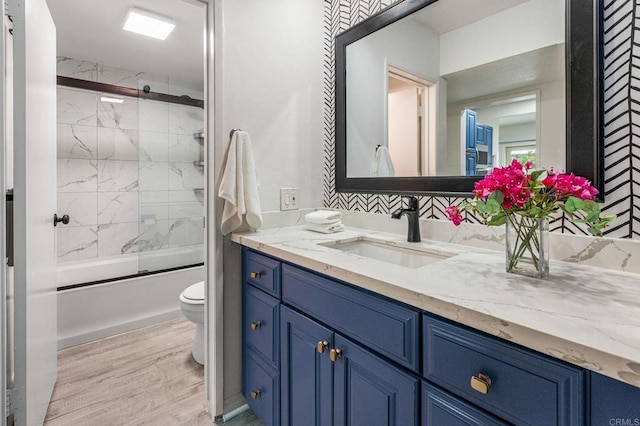 2929 Fire Mountain Dr Unit 9, Oceanside, CA 92054 - full bath featuring toilet, vanity, wood finished floors, and bath / shower combo with glass door
