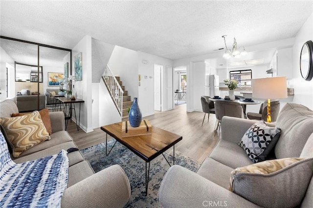 321 N Lincoln Ave Unit B, Monterey Park, CA 91755 - living area with a textured ceiling, stairs, wood finished floors, and a chandelier