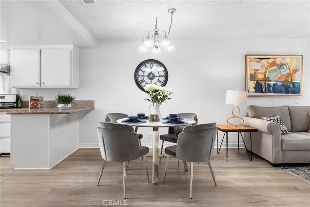 321 N Lincoln Ave Unit B, Monterey Park, CA 91755 - dining room with a textured ceiling, a chandelier, and light wood finished floors