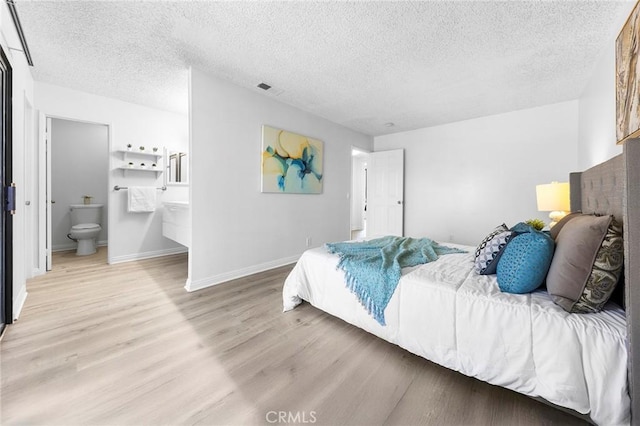 321 N Lincoln Ave Unit B, Monterey Park, CA 91755 - bedroom featuring a textured ceiling, light wood finished floors, and connected bathroom