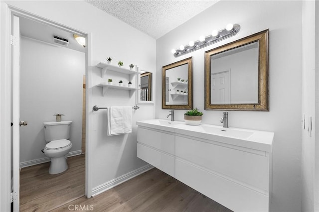 321 N Lincoln Ave Unit B, Monterey Park, CA 91755 - bathroom with wood finished floors, double vanity, and a textured ceiling