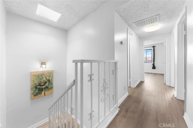 321 N Lincoln Ave Unit B, Monterey Park, CA 91755 - hallway featuring an upstairs landing, a textured ceiling, and wood finished floors