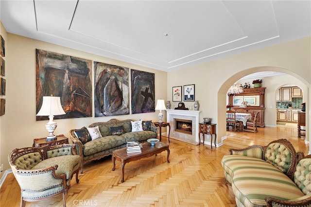 3805 Vista Azul, San Clemente, CA 92672 - living area with arched walkways, baseboards, a fireplace, and a tray ceiling