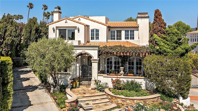 3805 Vista Azul, San Clemente, CA 92672 - mediterranean / spanish home with a gate, a chimney, a tiled roof, and stucco siding