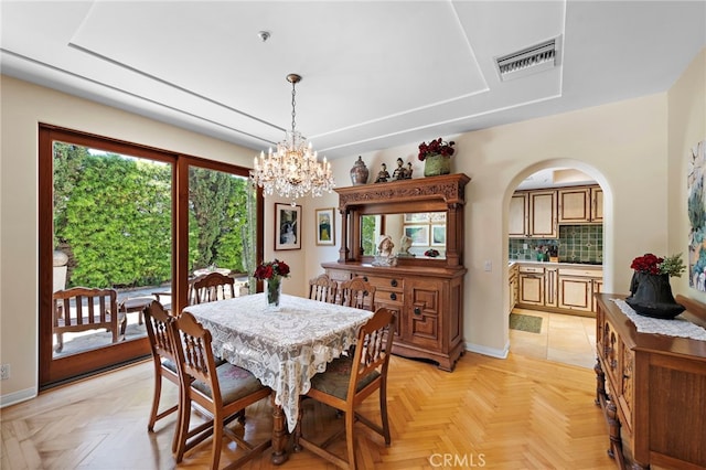 3805 Vista Azul, San Clemente, CA 92672 - dining room featuring a chandelier, a raised ceiling, arched walkways, and baseboards