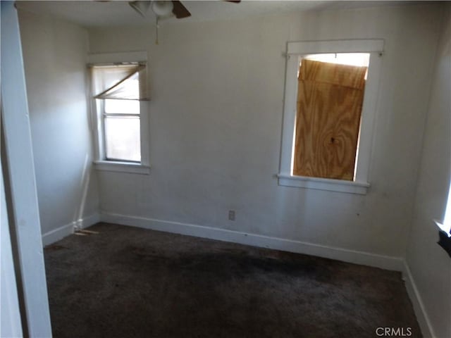 unfurnished room with carpet, ceiling fan, and baseboards