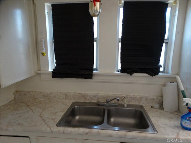 kitchen with a sink, healthy amount of natural light, and light countertops